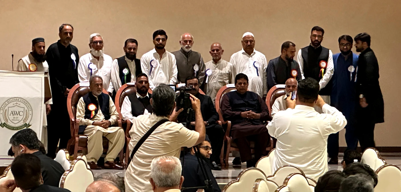 Office bearers of the Arain Welfare Community photographed together on stage at the annual gathering